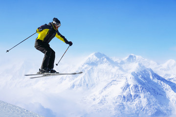 Jumping skier at mountains