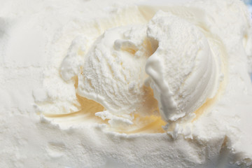 Top view of white vanilla ice cream surface with a ball