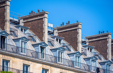 Residential lofts with balconies and large brick chimneys in Paris