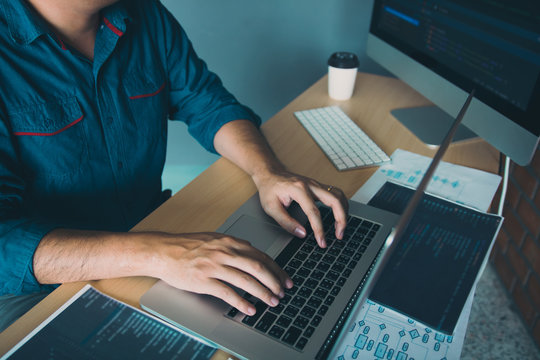 Asian man working code program developer computer web development working design software on desk in office.