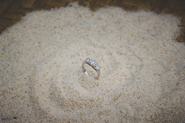 Beauty Gold Ring With DIamond Decoration On Above Sand. Photograpy Collection.