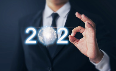 Businessman hands shows ok sign and growth success in 2020, modern circle global network connection, Technology iot (Internet of think). Business new year card.