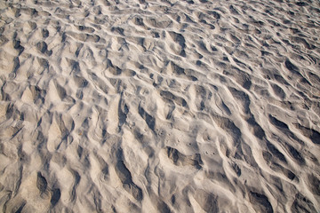 Fototapeta na wymiar drawings and footprints in the sand