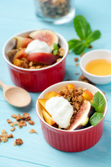 Fig and peach granola crisp served with cream closeup view
