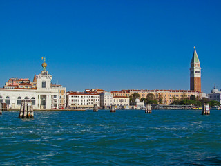 Fototapeta premium Grand Canal in Venice, Italy. Scenic panoramic view on Venetian landmarks - water surface and seafront with buildings and architecture attractions. 