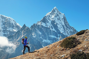 Fototapeta na wymiar Hiker walking in the mountains, freedom and happiness, achievement in mountains. Himalayas, Nepal