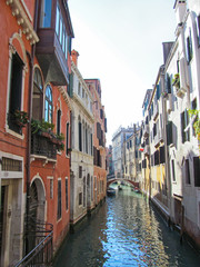 Water canal in Venice, Italy. Scenic view on Venetian landmarks - water surface and seafront with buildings and architecture attractions.