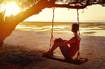 Young beautiful woman on sunset tropical beach, Thailand