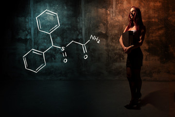 Sexy girl or secretary or female student presenting handdrawn chemical formula of Modafinil