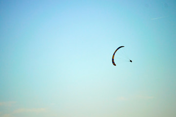 skydiver gliding in the sky with sunset
