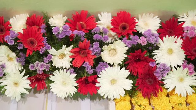 ndian festive decoration, red white and purple  flowers and green leaf arranged in alternate order,