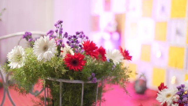 ndian festive decoration, red white and purple  flowers and green leaf arranged in alternate order,