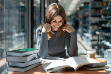 student preparing for exams at university public library