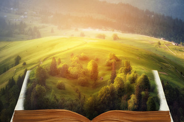 Fototapety  open fairytale magic book. beautiful mountain view. natural summer (spring) background. amazing landscape