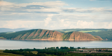 High rocky Yenisei river bank near Novosyolovo rural locality during sunset at Krasnoyarskiy krai, Siberia, Russia.