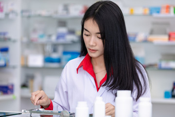 asian female pharmacist in the pharmacy concept