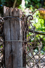 old wooden pole and metal fence