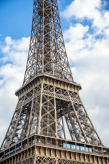 Truss Eiffel Tower on a cloudy sky background