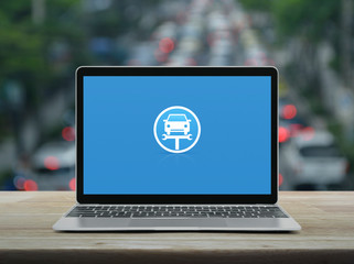 Service fix car with wrench tool flat icon on modern laptop computer on wooden table over blur of rush hour with cars and road in city, Business repair car online concept