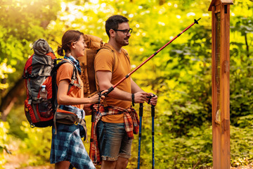 Cheerful couple hiking together in forest