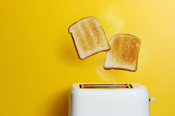 Slices of toast jumping out of the toaster - obrazy, fototapety, plakaty