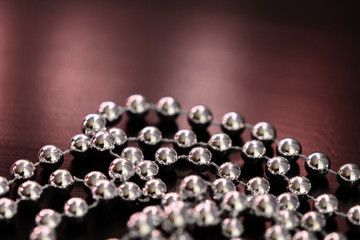 Silver Christmas decoration on a dark wooden background close up
