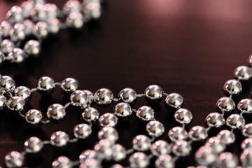 Silver Christmas decoration on a dark wooden background close up