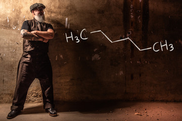 Bearded old man presenting handdrawn chemical formula of hexane