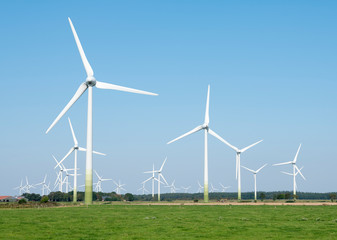 wind turbines in rural landscape of ostfriesland in the north of germany and blue sky