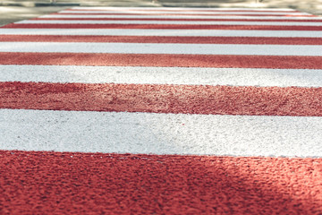 red and white crosswalk over the street in the city