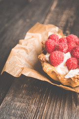Rasberry cake decorated with fresh ripe berries on the rustic background