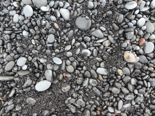 Fototapeta na wymiar Black sand and pebbles