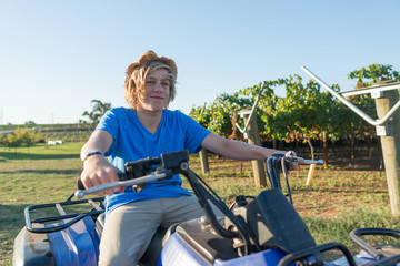 Young farmer riding quad bike © adam121
