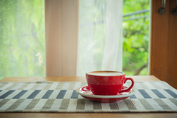 Red cup, Latte coffee heart shaped on wooden tablecloth