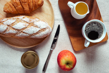Breakfast Natural Vegetarian Food With Sourdoughs Bread Bakery, Coffee, Honey, Croissant, Apple Fruit on Table., Homemade Fresh Baked French Sourdough for Breakfast. Food Nutrition/Beverage Concept