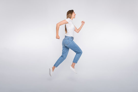 Full length body size photo of running urgent girl aspiring to reach something away while isolated with white background