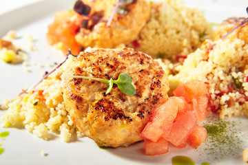 Turkey Meat Cutlets with Couscous Garnish on White Plate Isolated