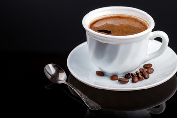 Cup of coffee on a black glass table