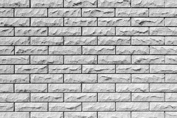 Weathered brick wall background. Beautiful decorative lining of the house outdoors side.