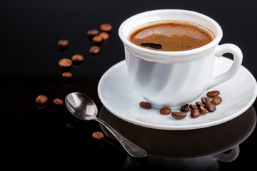 Cup of coffee on a black glass table
