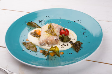 Cooked white fish fillet served with mashed potatoes