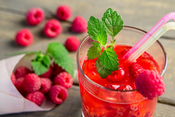 Glass of fresh strawberry summer cocktail and strawberries on the wooden background. Healthy food...