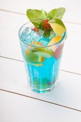 Glass of blue alcohol cocktail decorated