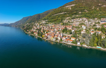 Fototapeta na wymiar Aerial view landscape on beatiful Lake Como in Carate Urio, Lombardy, Italy. Scenic small town with traditional houses and clear blue water. Summer tourist vacation on rich resort with nice harbour