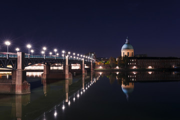 French ancient town Toulouse and Garonne river panoramic night view. Toulouse is the capital of Haute Garonne department and Occitanie region, France, South Europe. Famous tourist destionation.