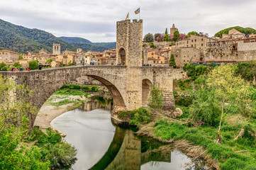 Fototapeta premium Panoramic landscape of Medieval village and castle in Besalu, Costa Brava, Spain. Besalu is a famous tourist destination in Spain, South Europe. Nice place for tourism near Mediterranean Sea