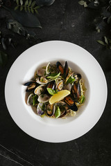 Exquisite Serving White Restaurant Plate of Spaghetti Nido with Sea Shells in Wine Sauce