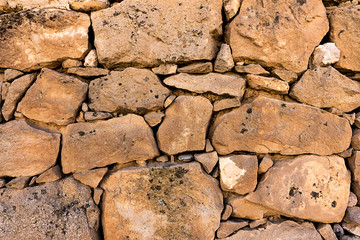 Ancient stone wall in a rural zone. Old stones texture. Dry stone 