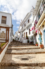 A narrow steep pattern paved alley in Frigiliana, an old Moorish village above Nerja, one of Andalucia's famous 