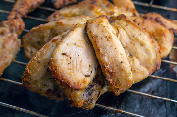 Grilled Chicken Breast with Slices Made for Marinade to Penetrate the Meat Better, and Ensure Chicken Cooked Evenly on Stainless Steel Cooking Grid.